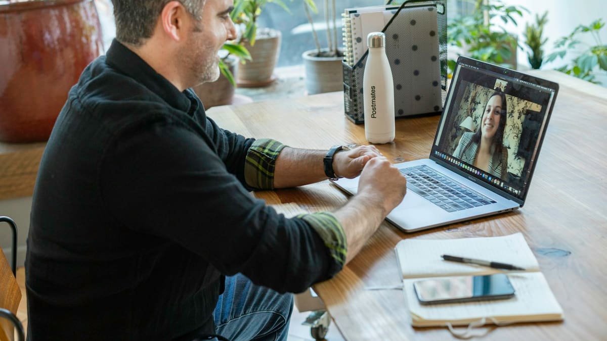 Man smiling during a video call on a laptop